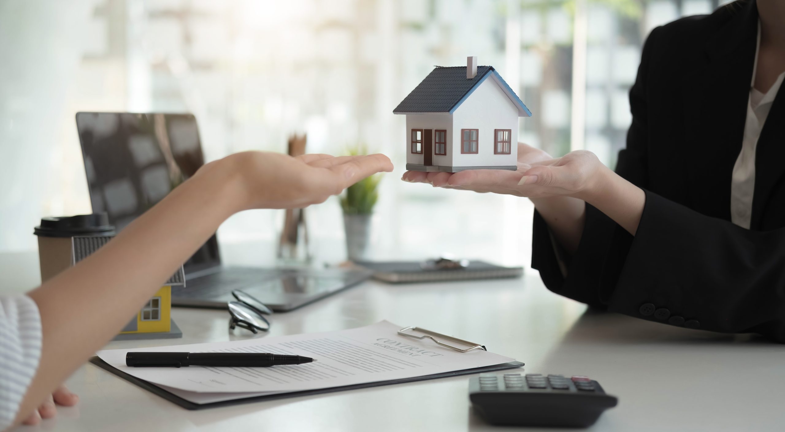 Sale representative offer house purchase contract to buy a house or apartment or discussing about loans and interest rates
